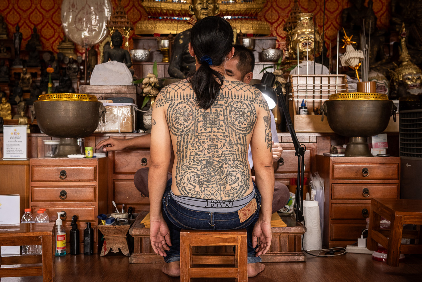 Full back Sak Yant tattoos in the workspace